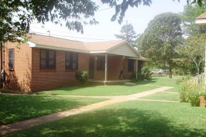 Shows the entrance to a brick style row house